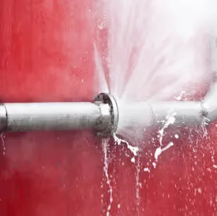 Frozen, burst pipe leaking water in a Raleigh-area home